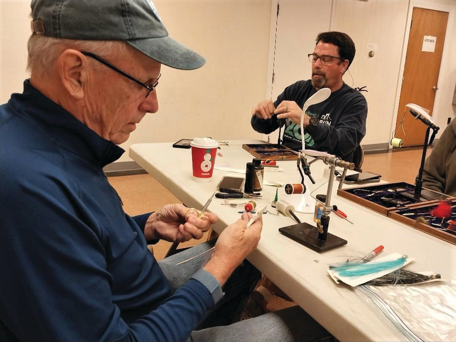 FLY TYING: Peter Burgess of Warwick instructs student Frank Flowers of Portsmouth at DEM’s fly tying program Monday evenings. Visit https://dem.ri.gov/events/fall-fly-tying-workshop.